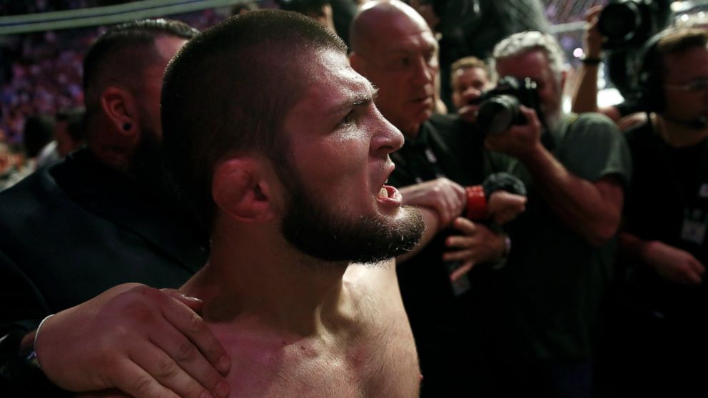 PHOTO: Khabib Nurmagomedov is held back outside of the cage after beating Conor McGregor in a lightweight title mixed martial arts bout at UFC 229 in Las Vegas, Saturday, Oct. 6, 2018. 
