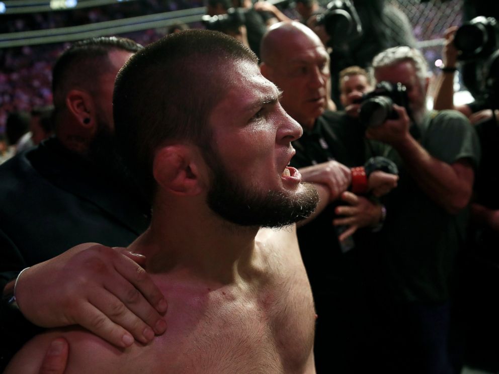 PHOTO: Khabib Nurmagomedov is held back outside of the cage after beating Conor McGregor in a lightweight title mixed martial arts bout at UFC 229 in Las Vegas, Saturday, Oct. 6, 2018.