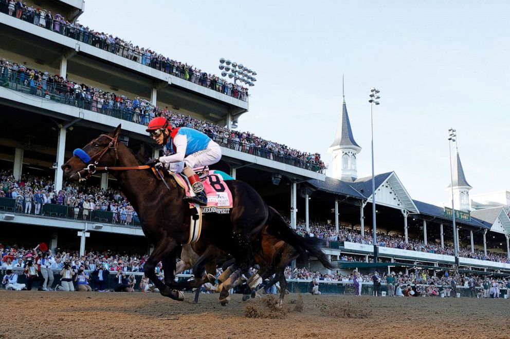 PHOTO: In this May 1, 2021, file photo, Medina Spirit #8, ridden by jockey John Velazquez, crosses the finish line to win the 147th running of the Kentucky Derby in Louisville, Ky.