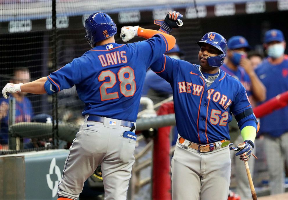 PHOTO: New York Mets' J.D. Davis (28) celebrates his two-run home run with teammate Yoenis Cespedes (52) to tie a baseball game in the fourth inning against the Atlanta Braves, July 31, 2020, in Atlanta.