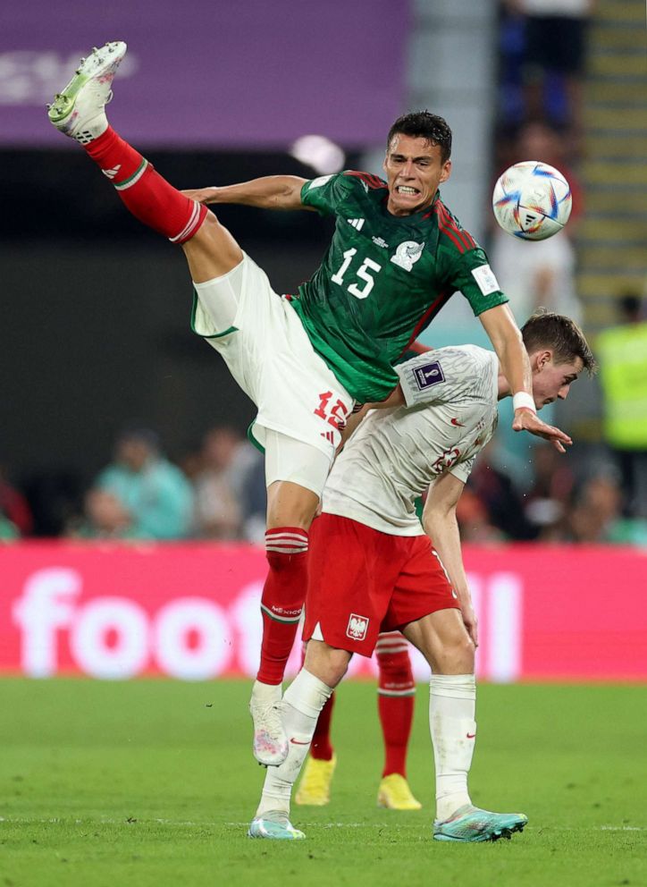 PHOTO: Mexico's Hector Moreno in action with Poland's Jakub Kaminski in World Cup Group C, Nov. 22, 2022.
