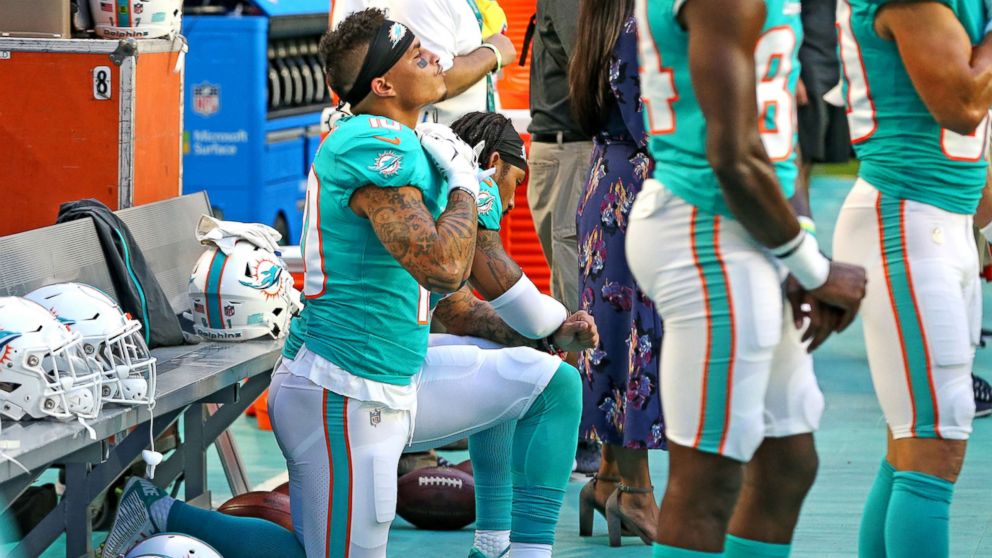 PHOTO: Miami Dolphins receivers Kenny Stills and Albert Wilson kneel during the national anthem as they prepare to play the Tampa Bay Buccaneers at Hard Rock Stadium in Miami Gardens, Fla., Aug. 9, 2018.