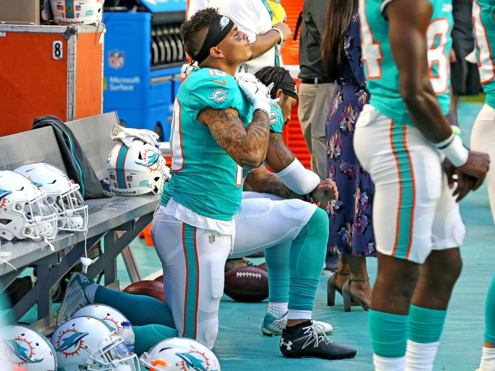 PHOTO: Miami Dolphins receivers Kenny Stills and Albert Wilson kneel during the national anthem as they prepare to play the Tampa Bay Buccaneers at Hard Rock Stadium in Miami Gardens, Fla., Aug. 9, 2018.