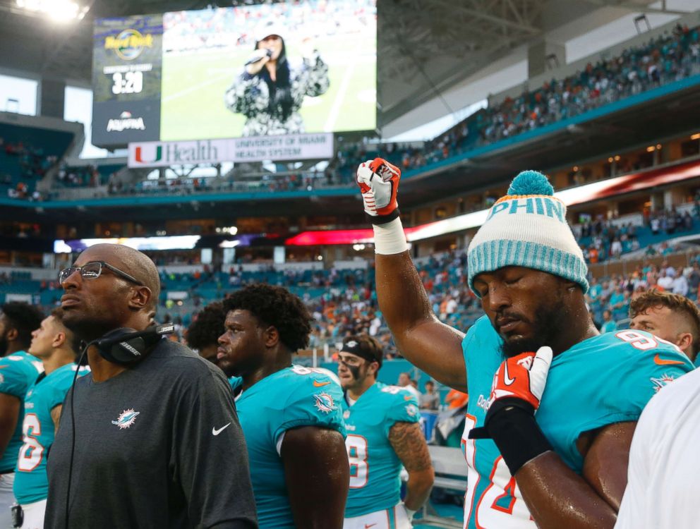 PHOTO: Miami Dolphins defensive end Robert Quinn raises his right fist during the singing of the national anthem, before the team's NFL preseason football game against the Tampa Bay Buccaneers, Aug. 9, 2018, in Miami Gardens, Fla.