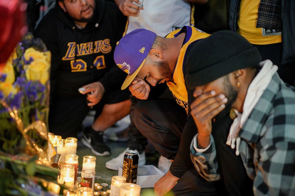 PHOTO: Mourners gather in Microsoft Square near the Staples Center to pay respects to Kobe Bryant after a helicopter crash killed the retired basketball star, in Los Angeles, on Jan. 26, 2020.