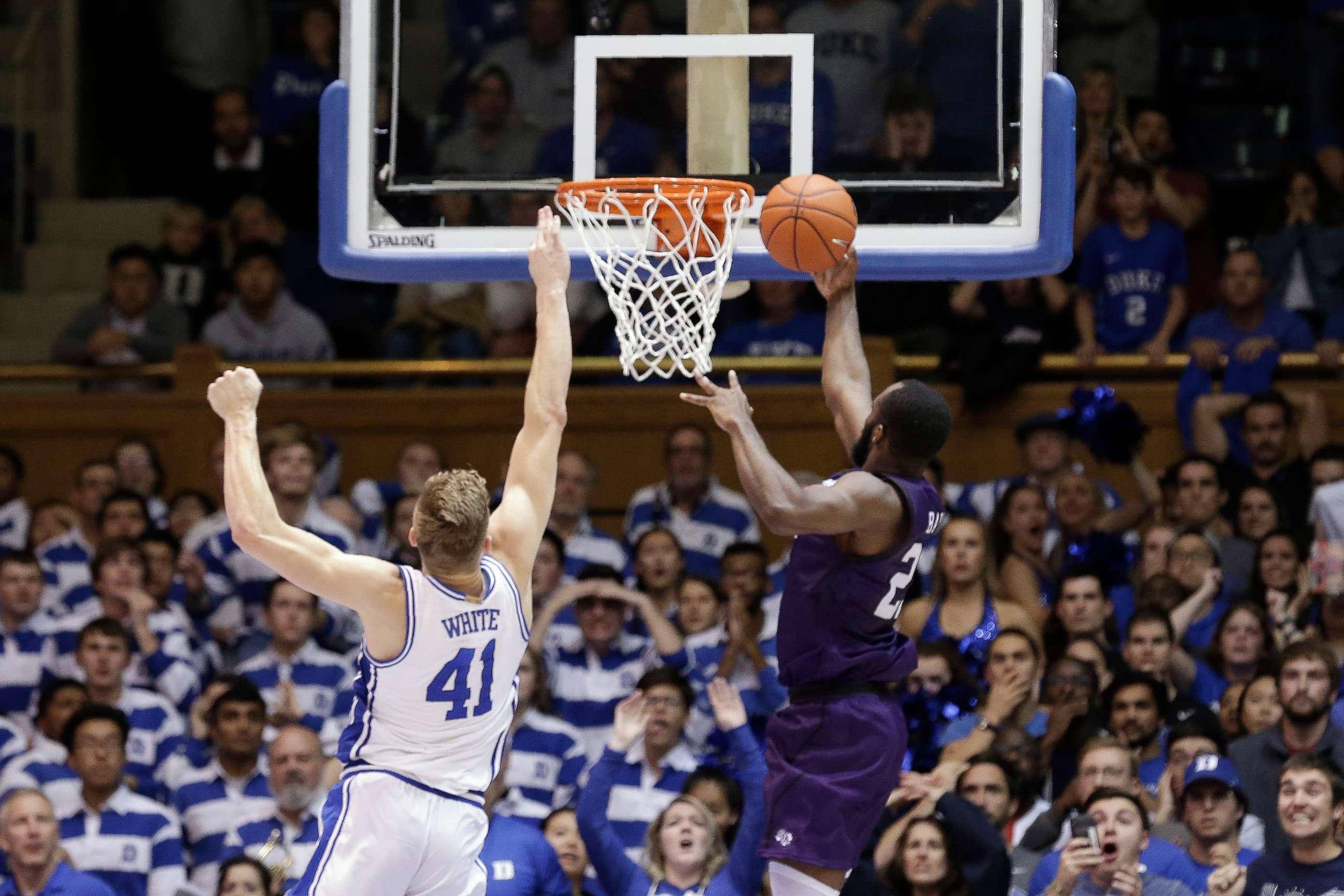 PHOTO: Stephen F. Austin forward Nathan Bain drives for a game-winning basket over Duke forward Jack White during overtime in an NCAA college basketball game in Durham, N.C., Tuesday, Nov. 26, 2019. 