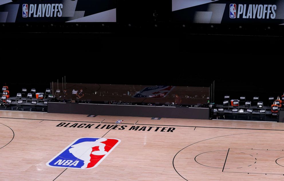 PHOTO: An empty court and bench are shown with no signage following the scheduled start time in Game 5 of an NBA basketball first-round playoff series, Wednesday, Aug. 26, 2020, in Lake Buena Vista, Fla.
