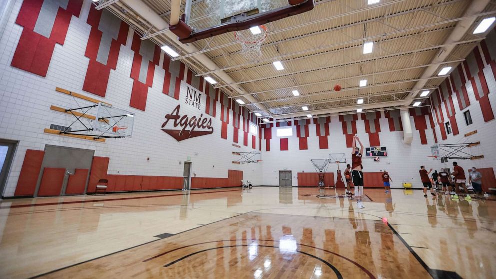 PHOTO: In this July 21, 2020, file photo, a New Mexico State player shoots a three at a pre-season practice for the NMSU men's basketball team in Las Cruces, N.M.