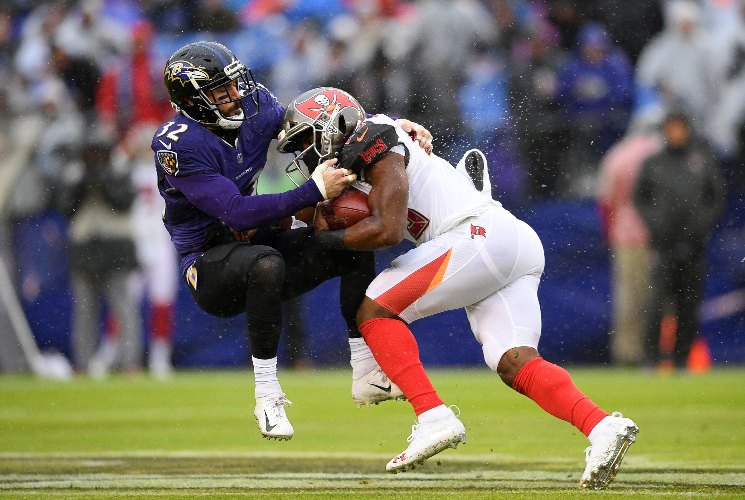 PHOTO: Tampa Bay Buccaneers running back Peyton Barber, right, rushes against Baltimore Ravens free safety Eric Weddle in the first half of an NFL football game, Sunday, Dec. 16, 2018, in Baltimore. 