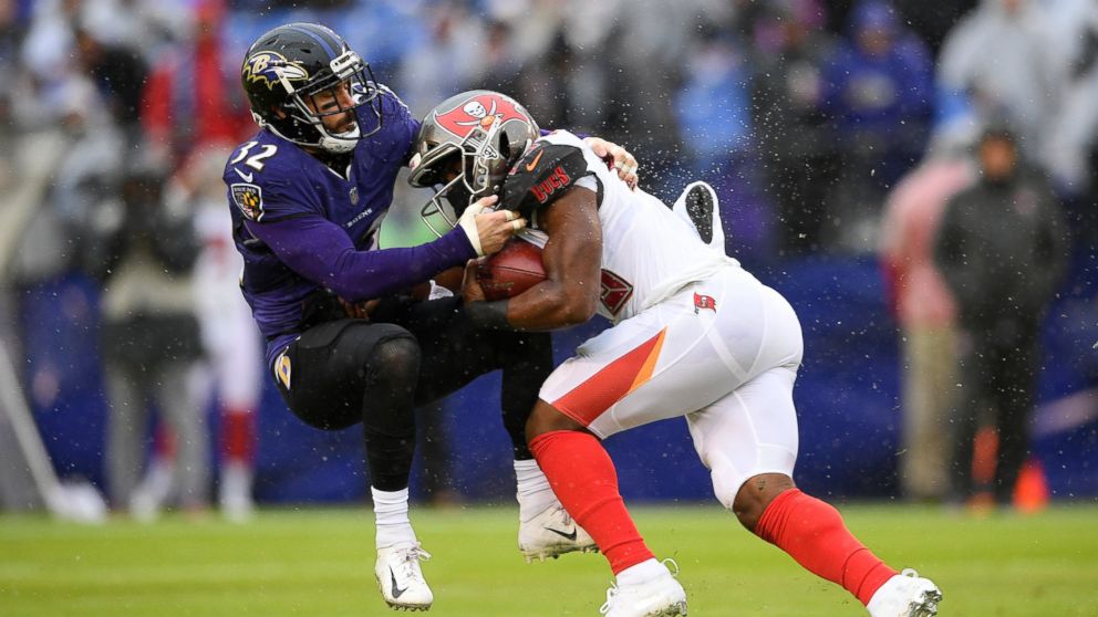PHOTO: Tampa Bay Buccaneers running back Peyton Barber, right, rushes against Baltimore Ravens free safety Eric Weddle in the first half of an NFL football game, Sunday, Dec. 16, 2018, in Baltimore. 