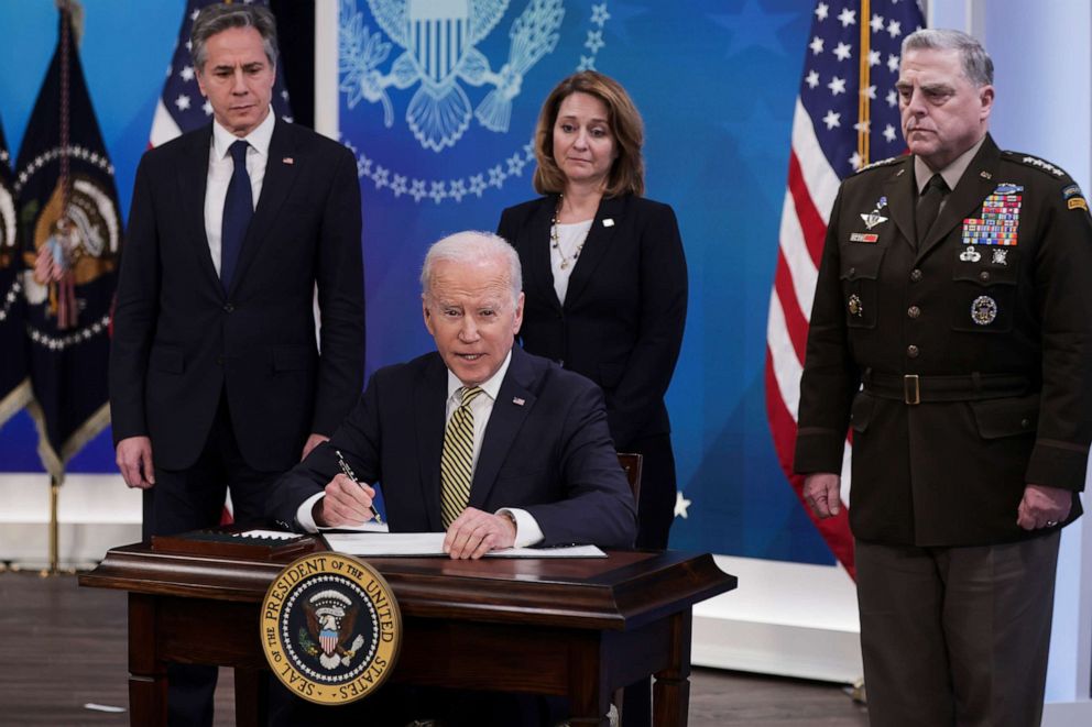 PHOTO: President Joe Biden signs legislative action providing security aid to Ukraine as Sec. of State Antony Blinken, Dep. Se. of Defense Kathleen Hicks and Chairman of the Joint Chiefs of Staff General Mark Milley look on, in Washington, March 16, 2022.