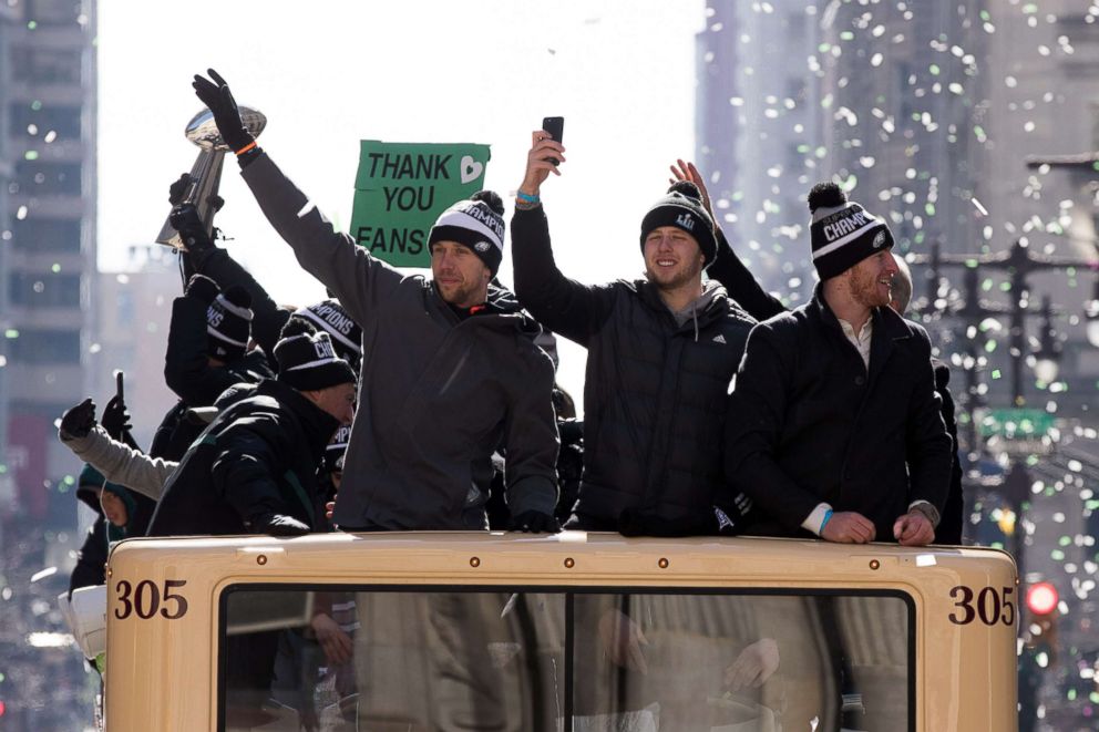 PHOTO: Philadelphia Eagles quarterbacks Nick Foles, Nate Sudfeld, and Carson Wentz ride atop a bus on the Super Bowl LII parade route in Philadelphia.