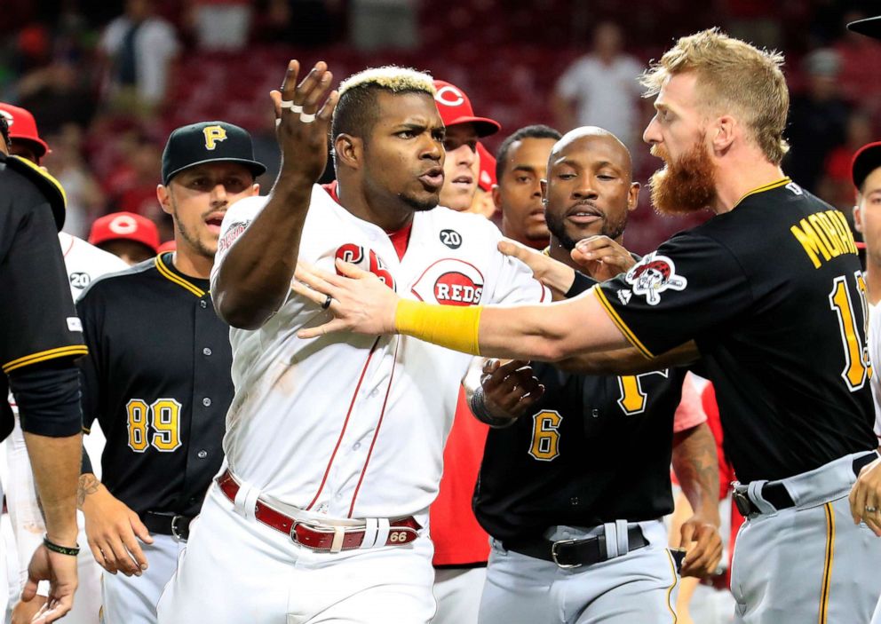 PHOTO: Yasiel Puig (No. 66) of the Cincinnati Reds is restrained during a bench clearing altercation against the Pittsburgh Pirates at Great American Ball Park on July 30, 2019 in Cincinnati.