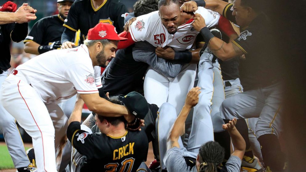 PHOTO: CINCINNATI, OHIO - JULY 30: Amir Garrett (No. 50, middle, white shirt) of the Cincinnati Reds engages members of the Pittsburgh Pirates during a bench clearing altercation July 30, 2019 in Cincinnati