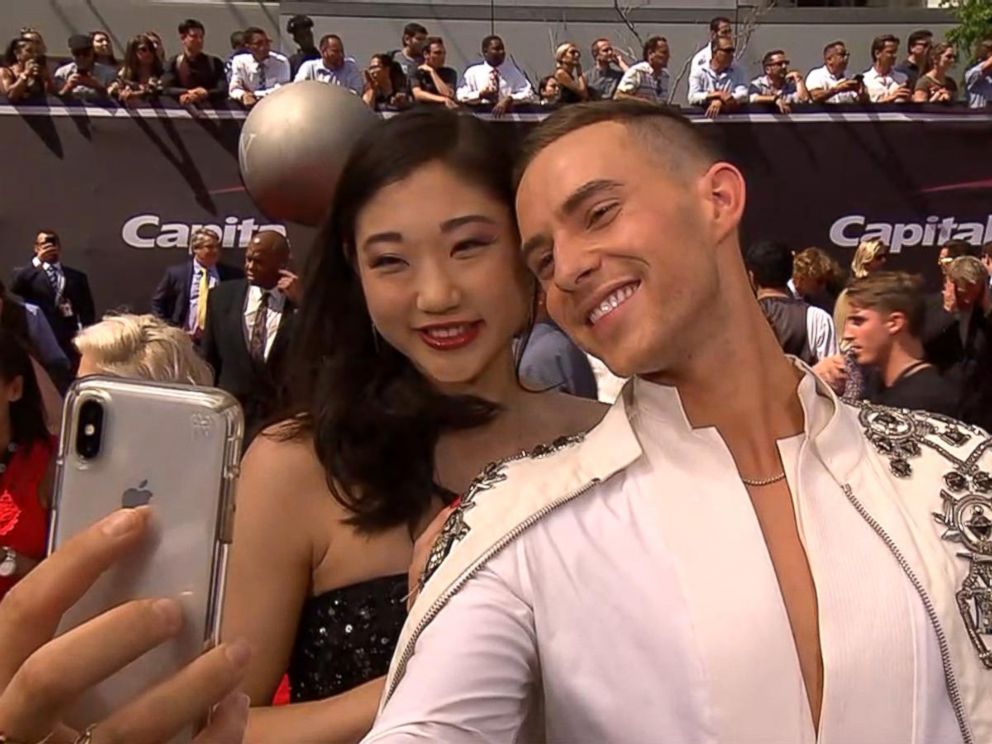 PHOTO: Adam Rippon and Mirai Nagasu snap a selfie together on the 2018 ESPY Awards red carpet.