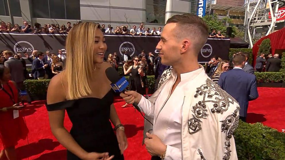 PHOTO: Adam Rippon talks with Chloe Kim on the 2018 ESPY Awards red carpet. 