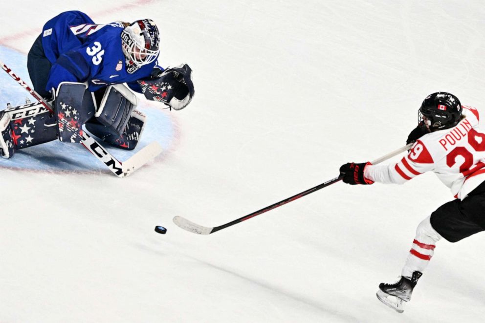 PHOTO: Canada's Marie-Philip Poulin scores a goal past USA's goaltender Madeline Rooney during the women's preliminary round group A match of the Beijing 2022 Winter Olympics ice hockey competition, at the Wukesong Sports Centre on Feb. 8, 2022.