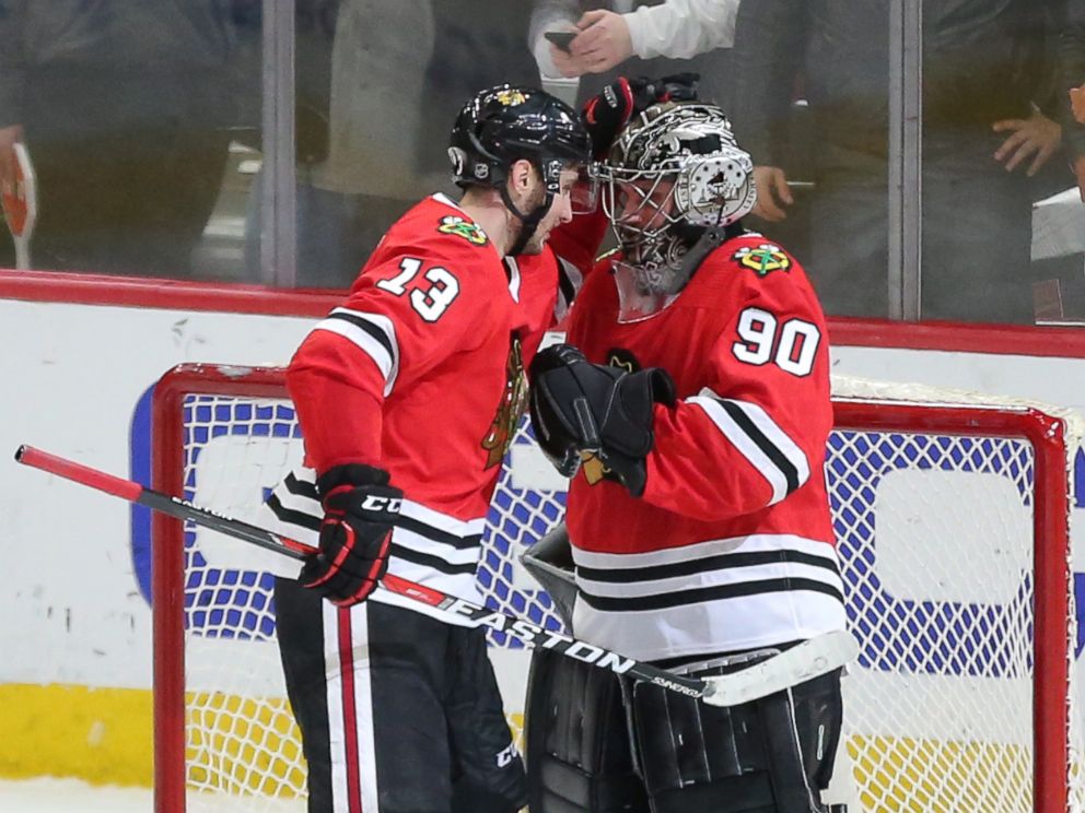 PHOTO: Chicago Blackhawks emergency goalie Scott Foster is congratulated by Tomas Jurco following the third period against the Winnipeg Jets at the United Center in Chicago, March 29, 2018.