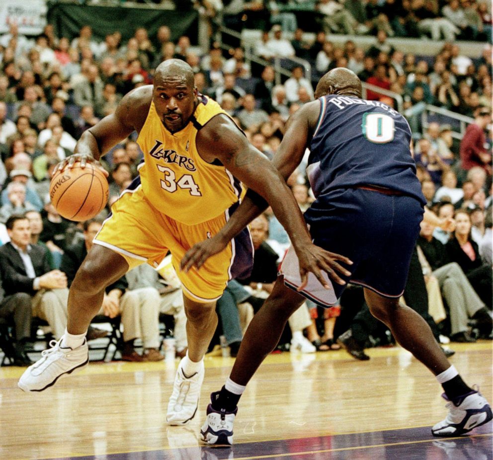 PHOTO: Los Angeles Lakers Shaquille O'Neal draws a foul from Utah Jazz Olden Polynice at the Staples Center in Los Angeles, Nov. 24, 1999.