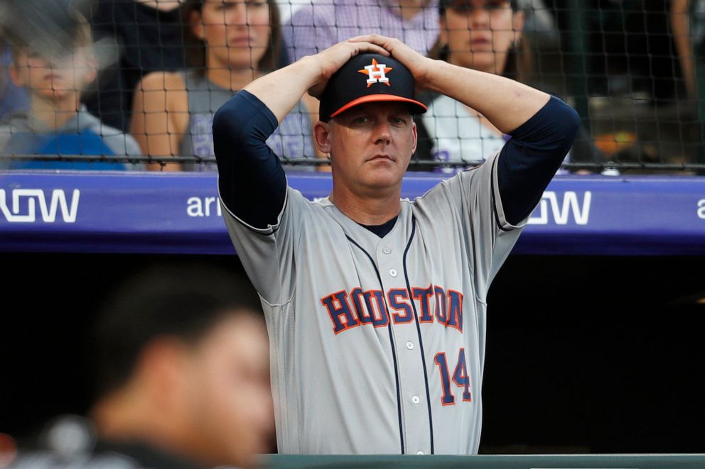 PHOTO: In this July 2, 2019, file photo, Houston Astros manager AJ Hinch reacts during a baseball game against the Colorado Rockies, in Denver.