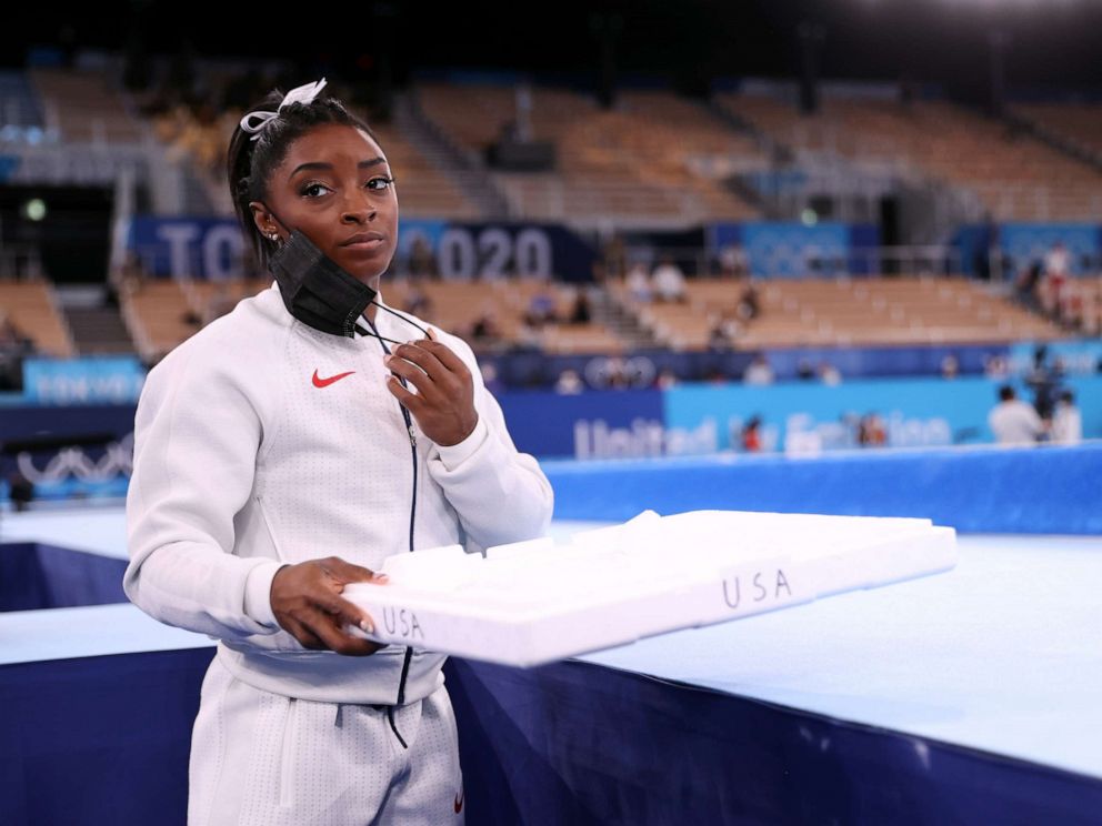 PHOTO: Simone Biles of Team United States supports her team mates by carrying their chalk after pulling out after the vault during the Women's Team Final on day four of the Tokyo 2020 Olympic Games at Ariake Gymnastics Centre, July 27, 2021 in Tokyo.