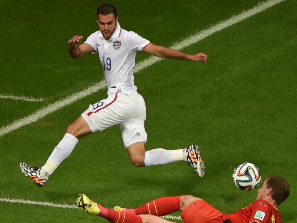 PHOTO: Graham Zusi of the U.S. vies with  Belgium's Jan Vertonghen during their match in Salvador, Brazil on July 1, 2014.