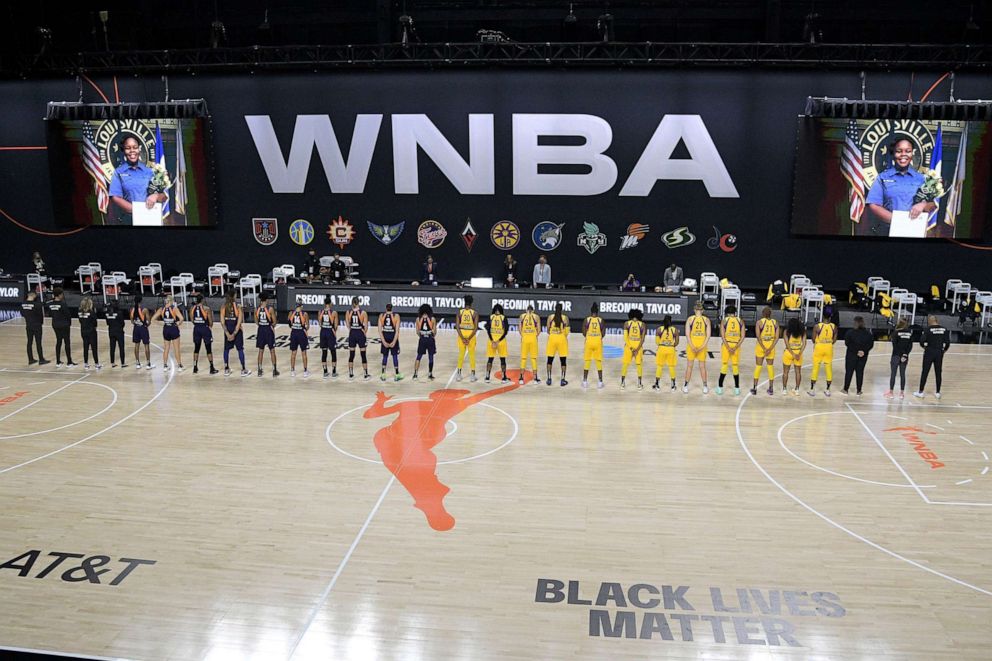 PHOTO: Members of the Phoenix Mercury, left, and Los Angeles Sparks stand for a moment of silence in honor of Breonna Taylor before a WNBA basketball game, July 25, 2020, in Ellenton, Fla.