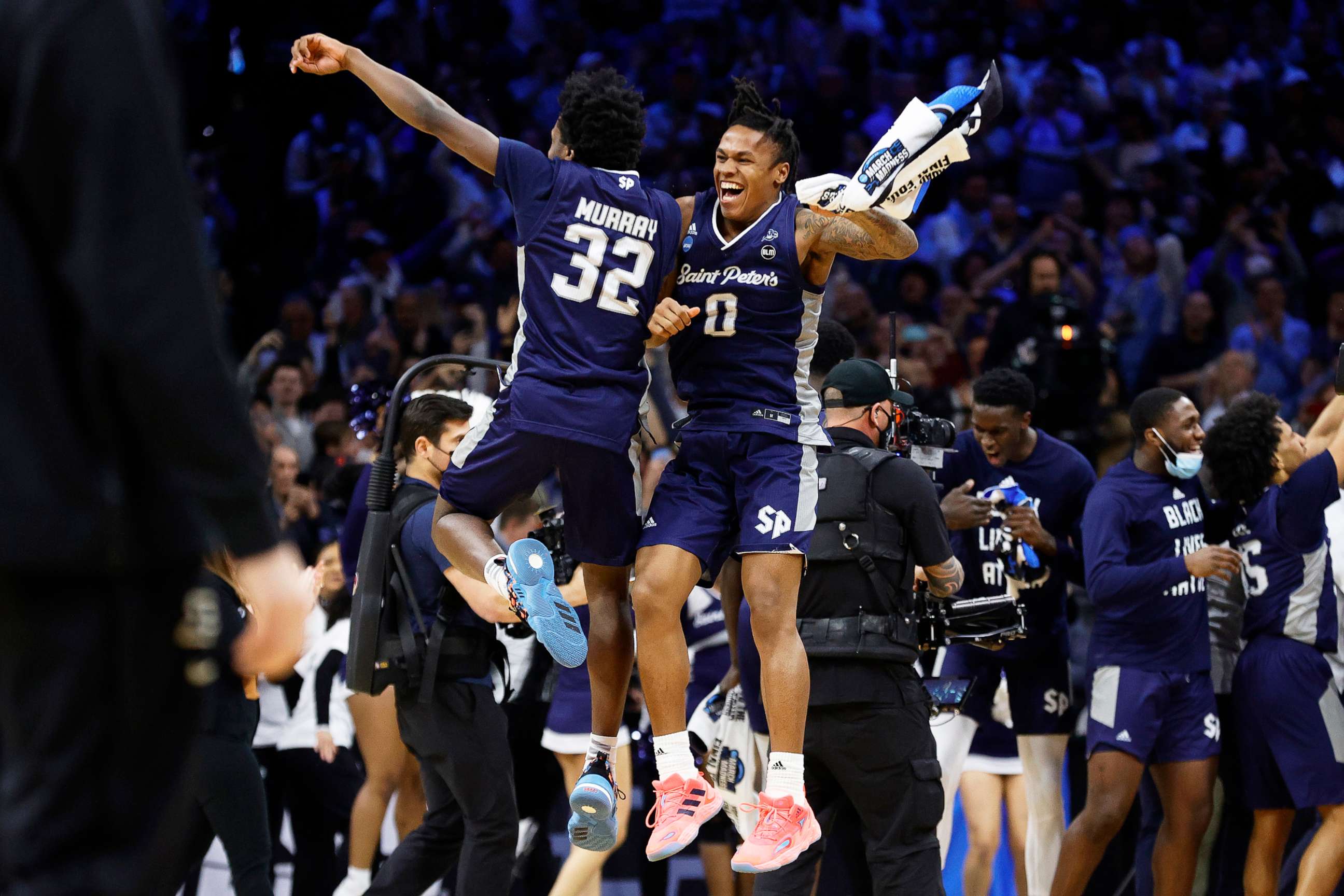 PHOTO: Jaylen Murray #32 and Latrell Reid #0 of the St. Peter's Peacocks celebrate after defeating the Purdue Boilermakers 67-64 in the Sweet Sixteen round game of the 2022 NCAA Men's Basketball Tournament on March 25, 2022, in Philadelphia.