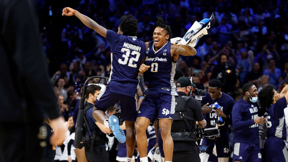 PHOTO: Jaylen Murray #32 and Latrell Reid #0 of the St. Peter's Peacocks celebrate after defeating the Purdue Boilermakers 67-64 in the Sweet Sixteen round game of the 2022 NCAA Men's Basketball Tournament on March 25, 2022, in Philadelphia.