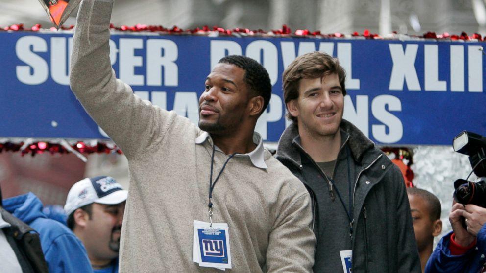 PHOTO: New York Giants' quarterback Eli Manning looks on as defensive end Michael Strahan, holds the Super Bowl trophy during a parade celebrating the New York Giants Super Bowl victory over the New England Patriots, Feb. 5, 2008, in New York City. 