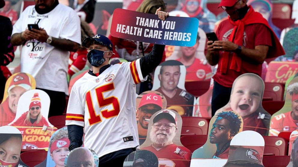 PHOTO: A fan holds up a sign honoring heart care workers before the NFL Super Bowl 55 football game between the Kansas City Chiefs and Tampa Bay Buccaneers, Feb. 7, 2021, in Tampa, Fla.