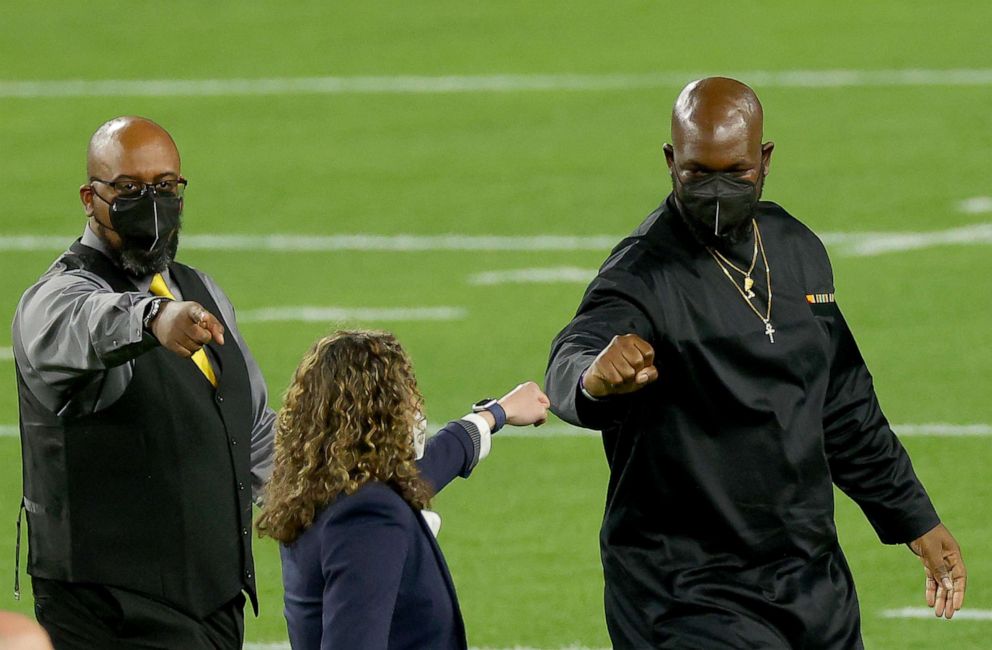 PHOTO: Honorary Super Bowl captains, nurse Suzie Dorner, educator Trimaine Davis and veteran James Martin react on the field before Super Bowl LV between the Tampa Bay Buccaneers and the Kansas City Chiefs on Feb. 7, 2021 in Tampa, Fla.