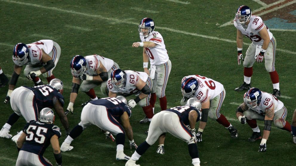 PHOTO: Quarterback Eli Manning #10 of the New York Giants points as he calls out signals prior to the snap at the line of scrimmage against the New England Patriots during Super Bowl XLII at University of Phoenix Stadium, Feb. 3, 2008, in Glendale, Ariz. 