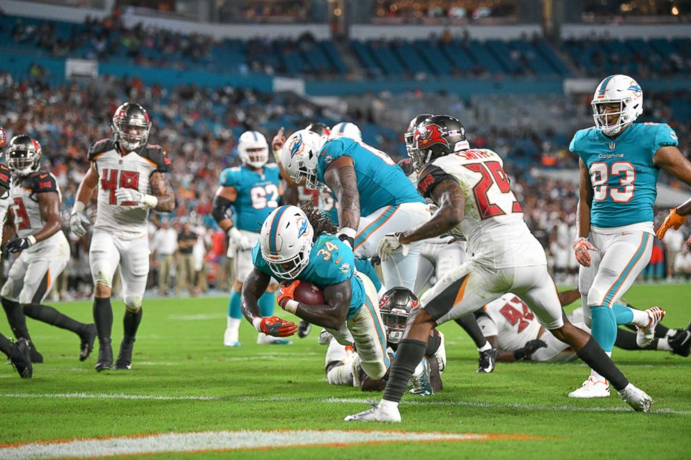 PHOTO: Senorise Perry #34 of the Miami Dolphins scores a touchdown in the second quarter during a preseason game against the Tampa Bay Buccaneers at Hard Rock Stadium, Aug. 9, 2018, in Miami, Florida.