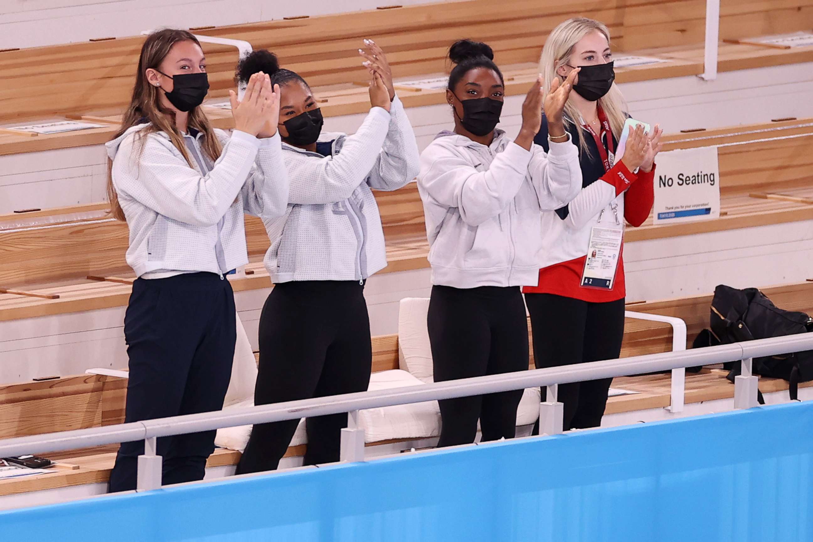 PHOTO: TOKYO, JAPAN - JULY 29: (L-R) Riley McCusker, Jordan Chiles, Simone Biles, and Mykayla Skinner of Team United States,cheer after Sunisa Lee won the gold medal in the Women's All-Around Final on day six of the Tokyo 2020 Olympic Games.