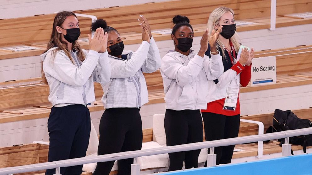 PHOTO: TOKYO, JAPAN - JULY 29: (L-R) Riley McCusker, Jordan Chiles, Simone Biles, and Mykayla Skinner of Team United States,cheer after Sunisa Lee won the gold medal in the Women's All-Around Final on day six of the Tokyo 2020 Olympic Games.
