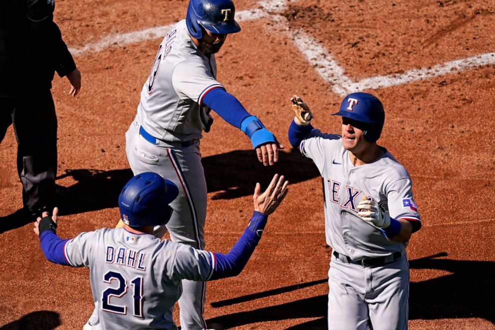 PHOTO: Texas Rangers' Nick Solak, right, celebrates with Joey Gallo (13) and David Dahl (21) during the first inning against the Kansas City Royals, April 1, 2021, in Kansas City, Mo.