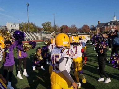 PHOTO: The Woodland Tigers youth football team runs onto the field in fall game.