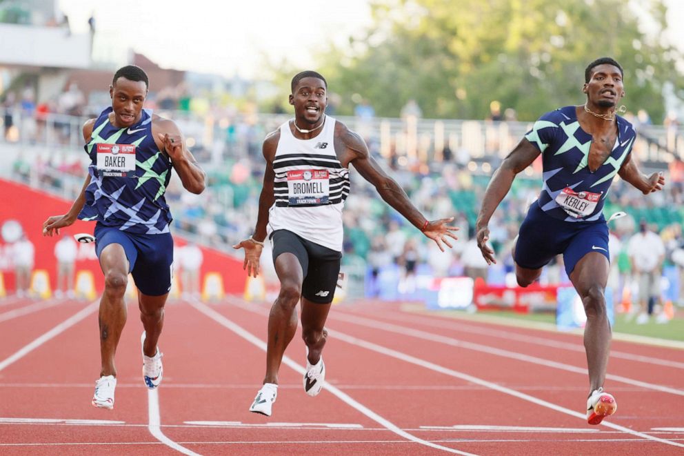 PHOTO: Trayvon Bromell, Ronnie Baker and Fred Kerley cross the finish line in the men's 100-meter final on day three of the 2020 U.S. Olympic track and field trials at Hayward Field on June 20, 2021, in Eugene, Ore.