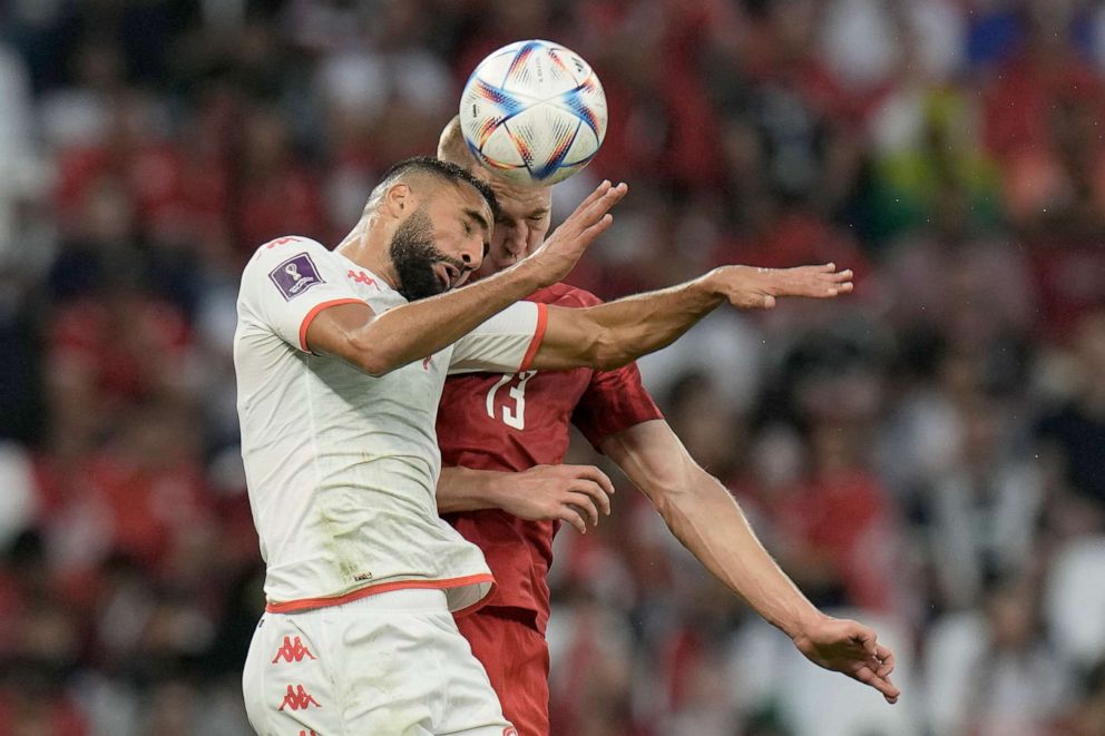 PHOTO: Tunisia's Ali Abdi, left, and Denmark's Rasmus Kristensen challenge for the ball during the World Cup group D soccer match between Denmark and Tunisia, at the Education City Stadium in Al Rayyan, Qatar, Tuesday, Nov. 22, 2022.