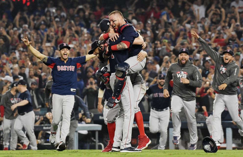 PHOTO: Christian Vazquez #7 jumps into the arms of Chris Sale #41 of the Boston Red Sox to celebrate their 5-1 win over the Los Angeles Dodgers in Game Five to win the 2018 World Series at Dodger Stadium, Oct. 28, 2018, in Los Angeles.