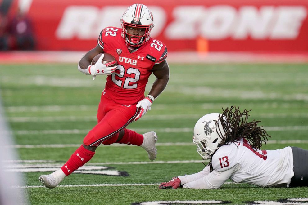 PHOTO: Utah running back Ty Jordan runs for a score as he eludes a tackle by Washington State linebacker during the second half of an NCAA college football game in Salt Lake City, Dec. 19, 2020.