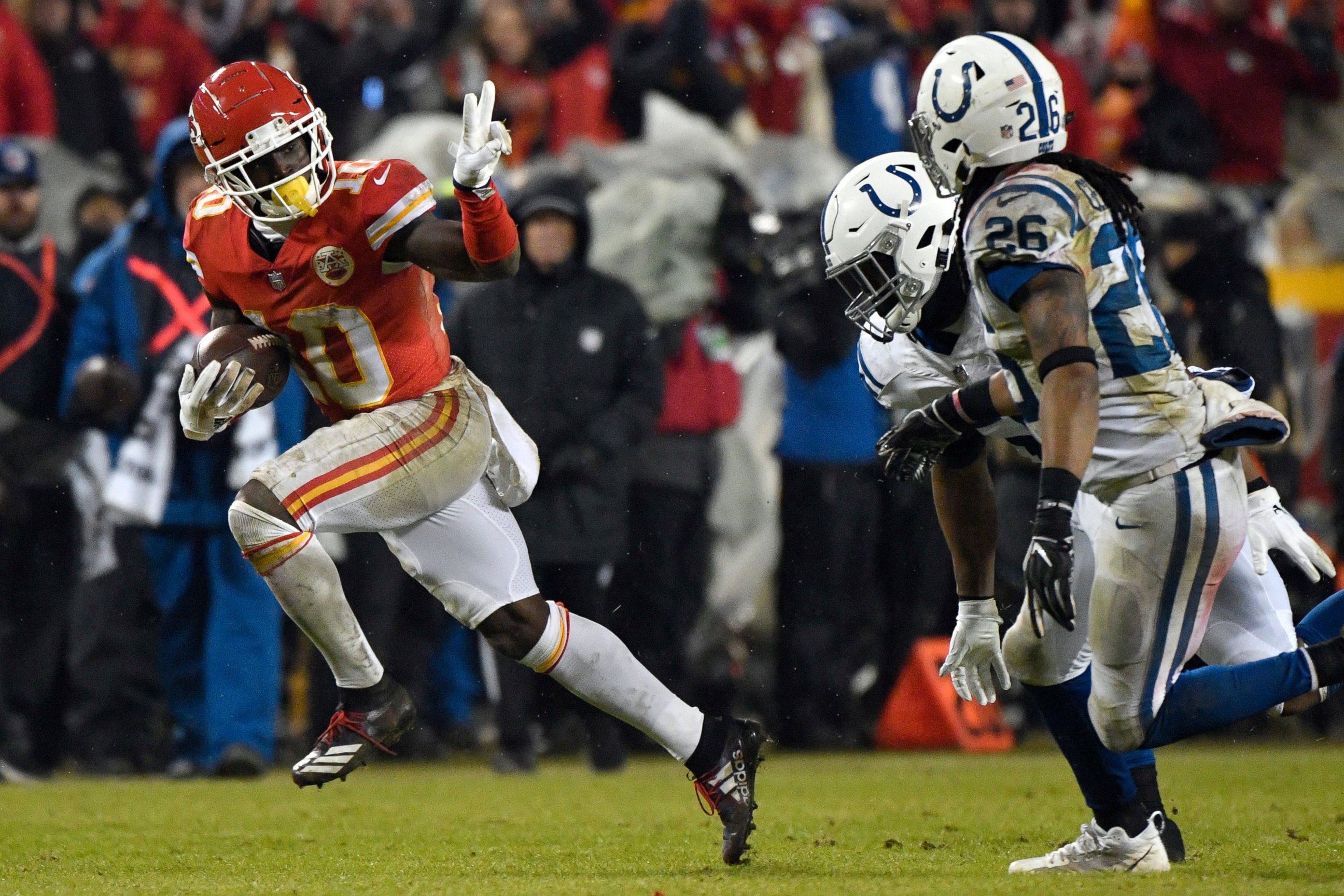 PHOTO: In this Jan. 12, 2019, file photo, Chiefs wide receiver Tyreek Hill gestures as he runs past Colts safety Clayton Geathers and linebacker Anthony Walker during the second half of an NFL divisional football playoff game in Kansas City, Mo.