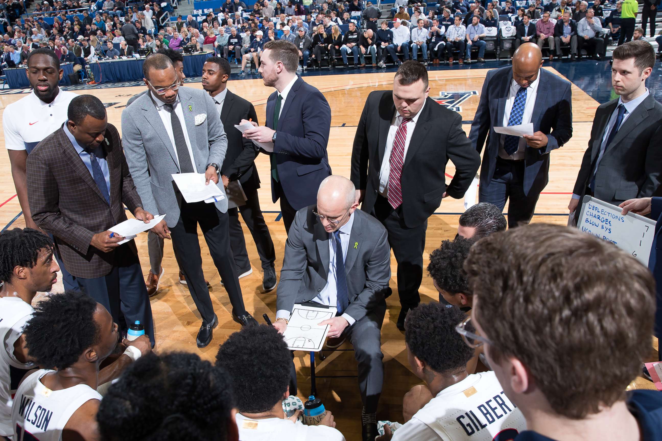 PHOTO: The University of Connecticut men's basketball team stands in a huddle with coach Dan Hurley during a game.