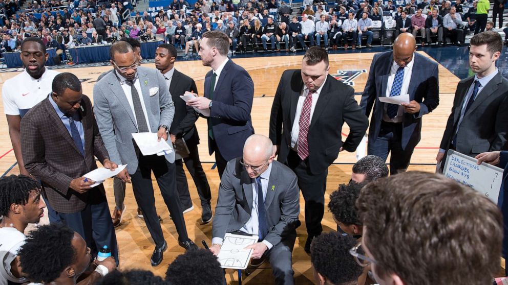 PHOTO: The University of Connecticut men's basketball team stands in a huddle with coach Dan Hurley during a game.