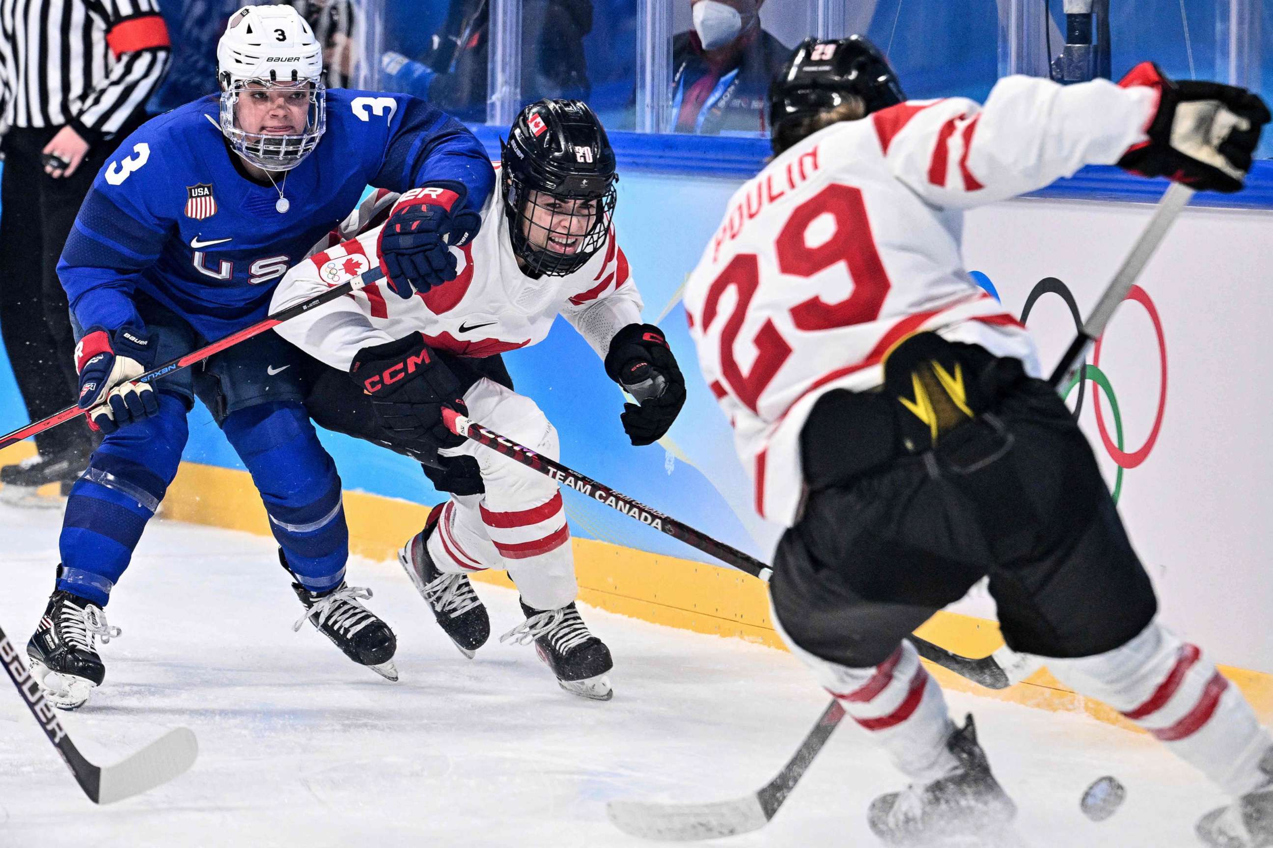 PHOTO: Canada's Sarah Nurse, center, and Marie-Philip Poulin vie for the puck against USA's Cayla Barnes during a women's preliminary round group A match of the Beijing Winter Olympics ice hockey competition in Beijing on Feb. 8, 2022.