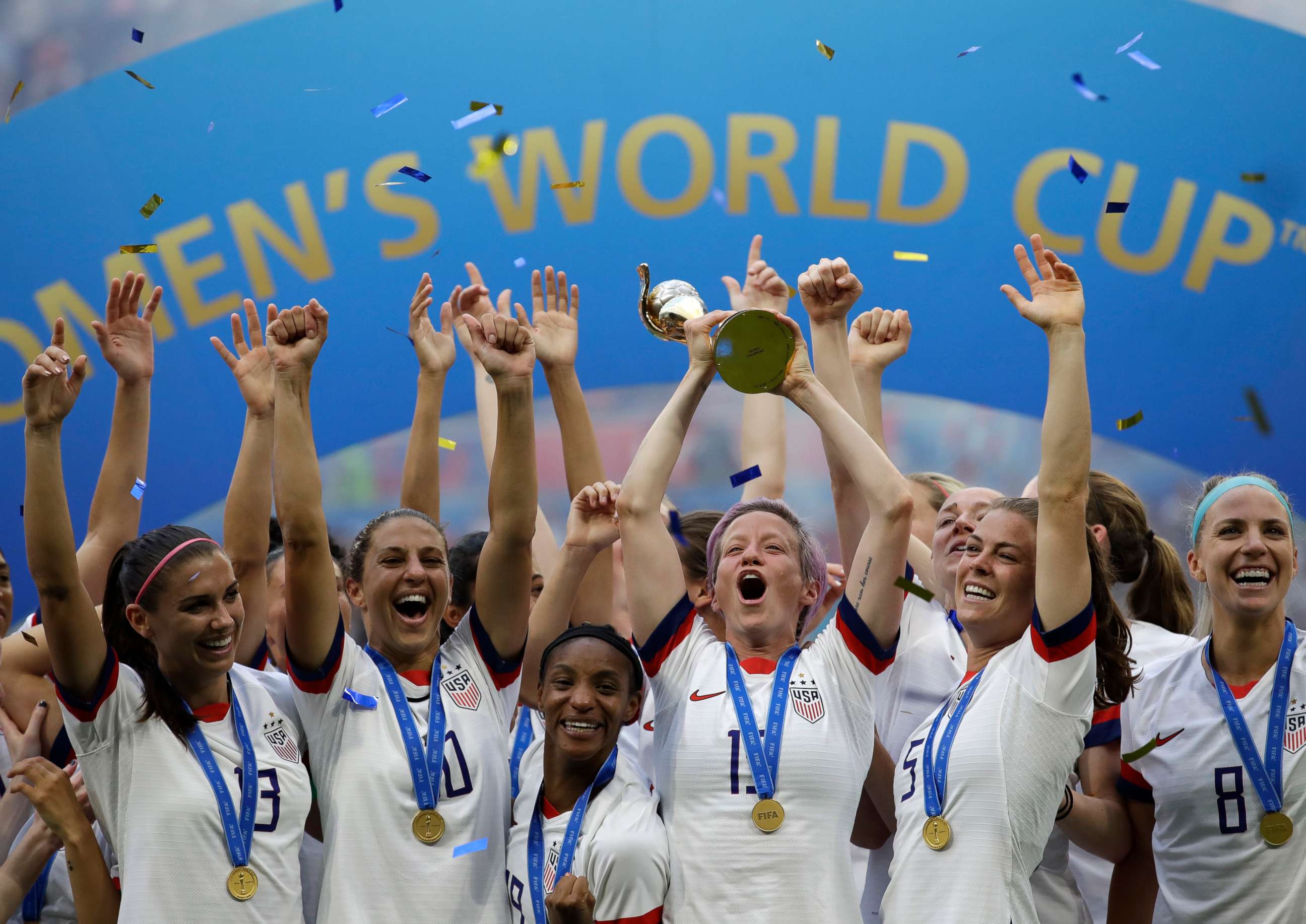 PHOTO: In this July 7, 2019, file photo, United States' Megan Rapinoe lifts up a trophy after winning the Women's World Cup final soccer match between US and The Netherlands at the Stade de Lyon in Decines, outside Lyon, France. 