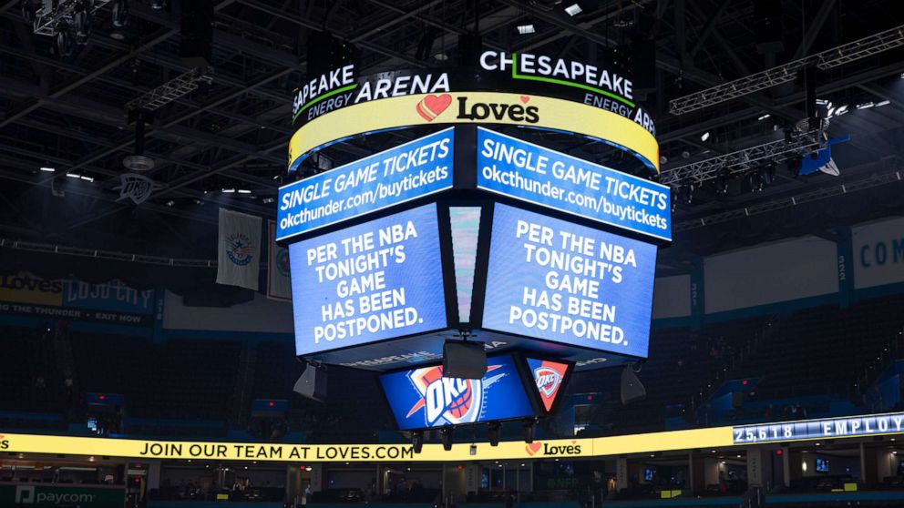 PHOTO: A message on the video score board informs fans the Oklahoma City Thunder game against the Utah Jazz on March 11, 2020, has been postponed. Teams were told to go to the locker rooms just before tip off at Chesapeake Energy Arena. 