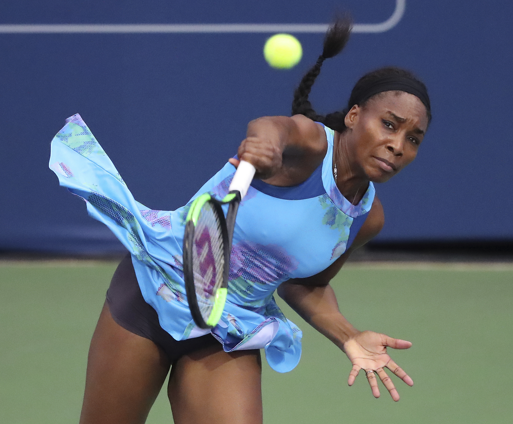 PHOTO: Venus Williams serves to Canada's Genie Bouchard in a special women's exhibition tennis match at the BB&T Atlanta Open Tournament, July 23, 2017, in Atlanta. 