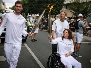 A Lebanese photojournalist, wounded in Israeli strike, carries Olympic torch to honor journalists